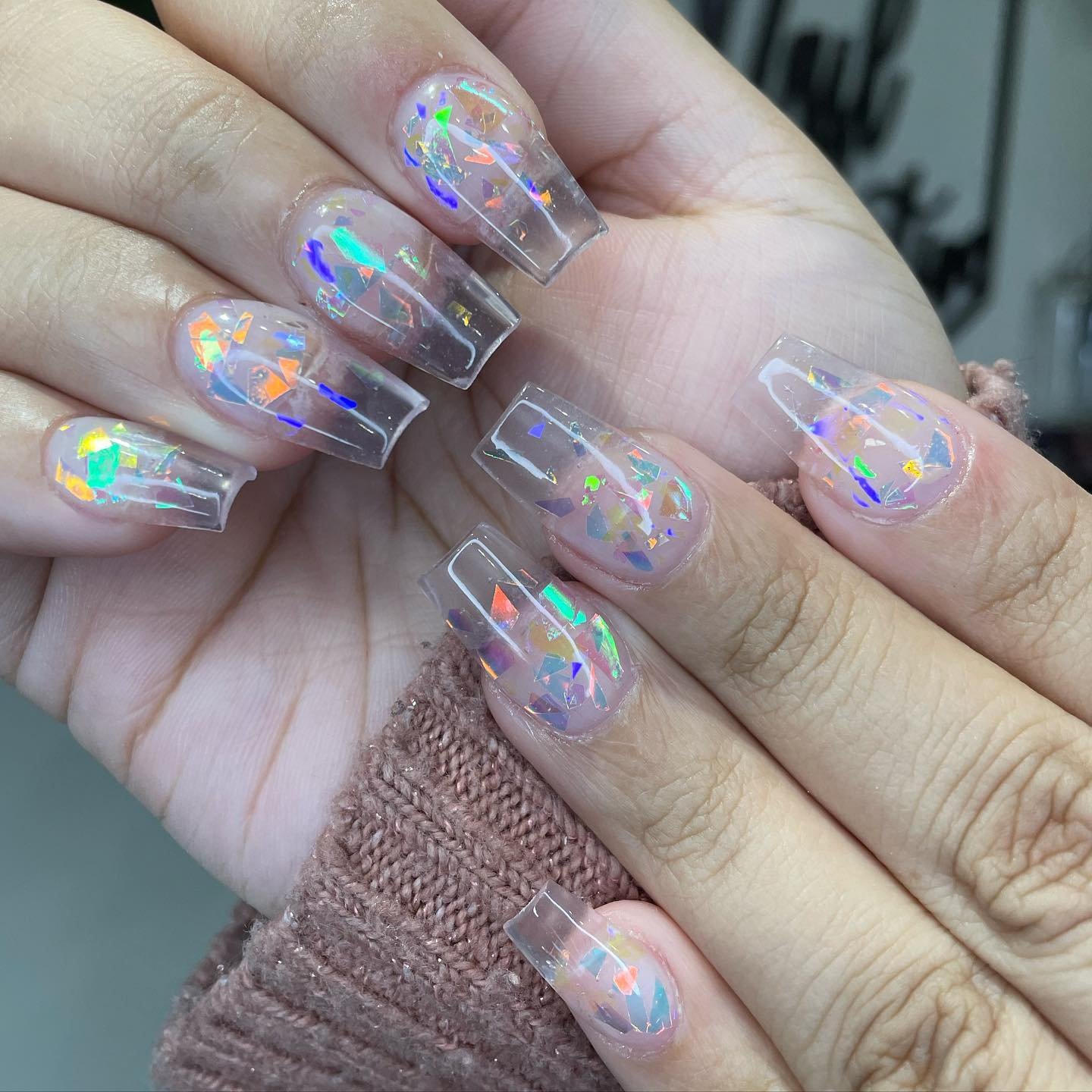 Bold coffin clear nails ideas packed with rainbow holographic flakes for maximum shine and color