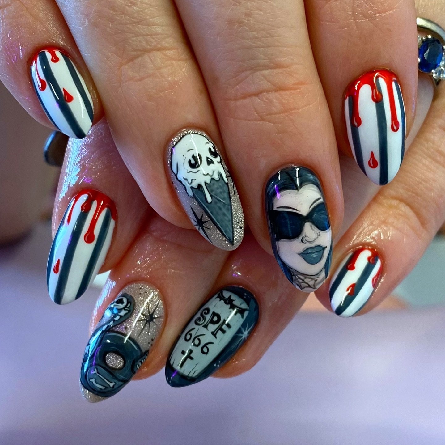Unleash your dark side with these creepy emo nails ideas featuring blood-drip stripes, skull ice cream, vampire portraits, and “SPF 666” coffin designs