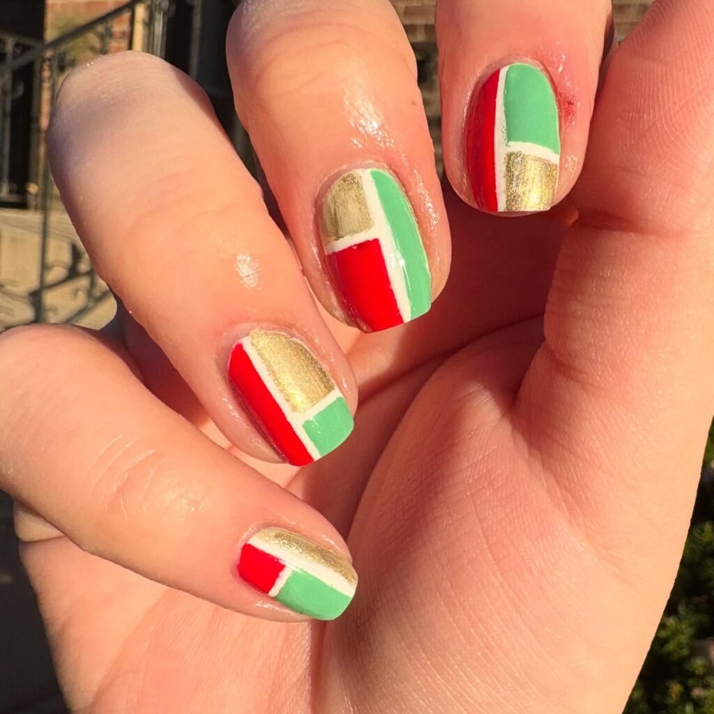 Striking red, green, white, and gold geometric painted nails ideas featuring modern color blocking