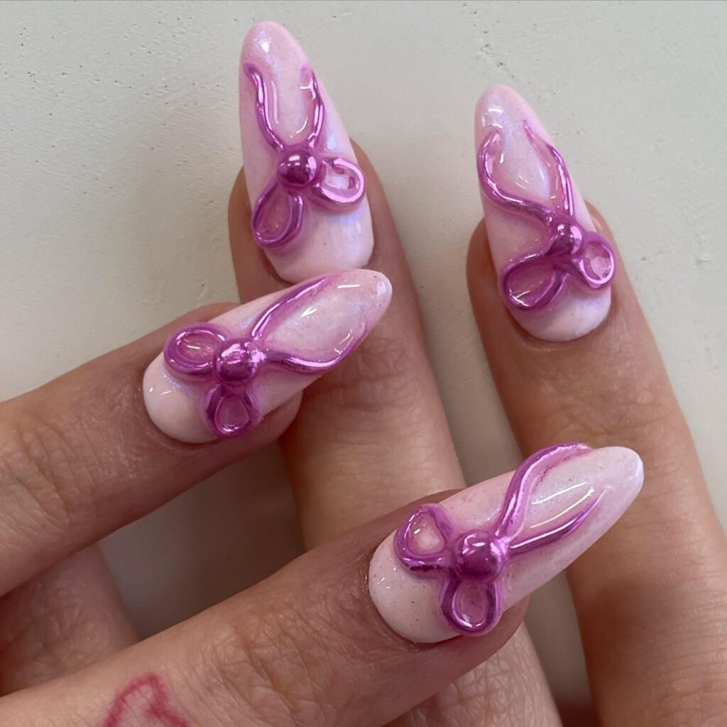 Soft pink nails with glossy purple 3D ballerina ribbon bows ballerina nails designs ideas