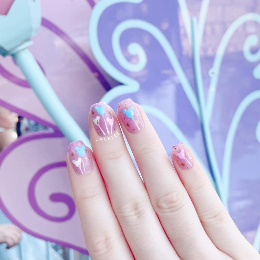 Fun pink Mickey and Minnie balloon gender reveal nails ideas with gold accents