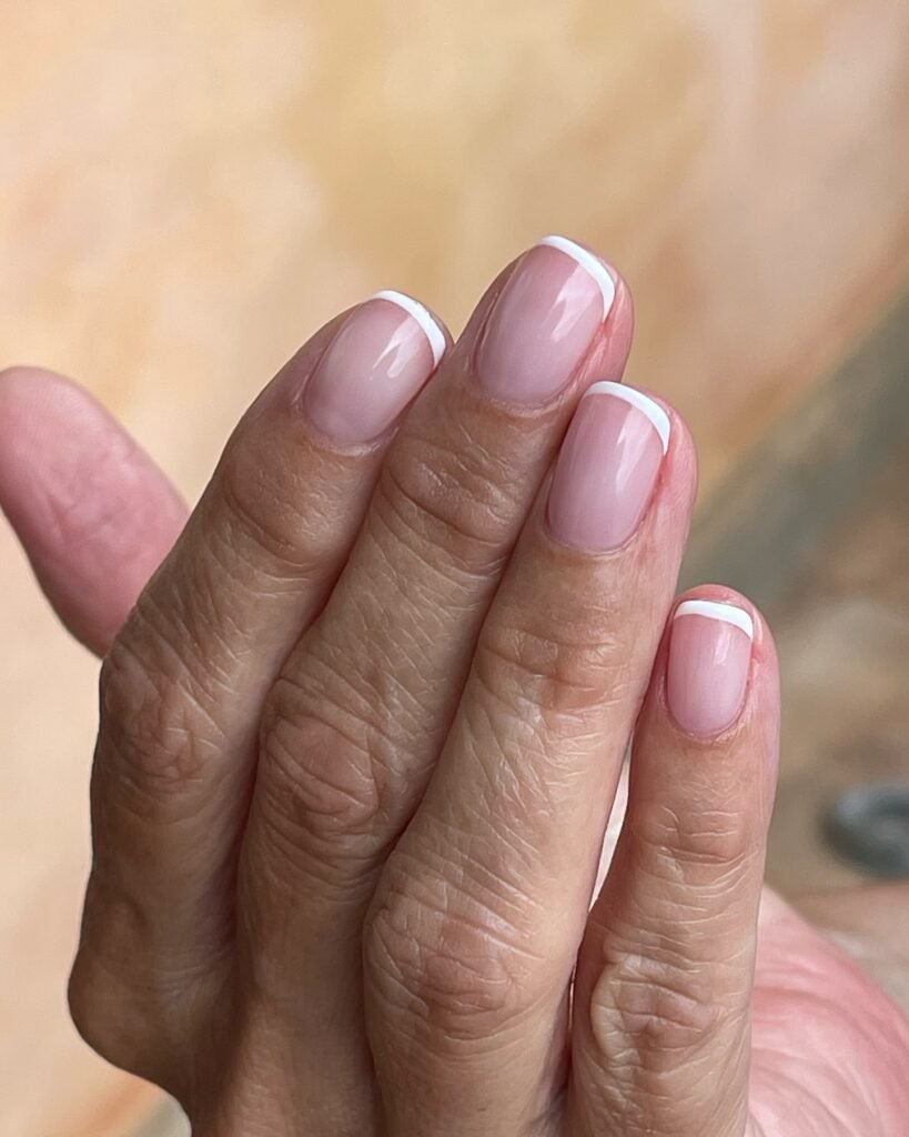 Timeless French tip senior nails ideas on soft pink natural nails