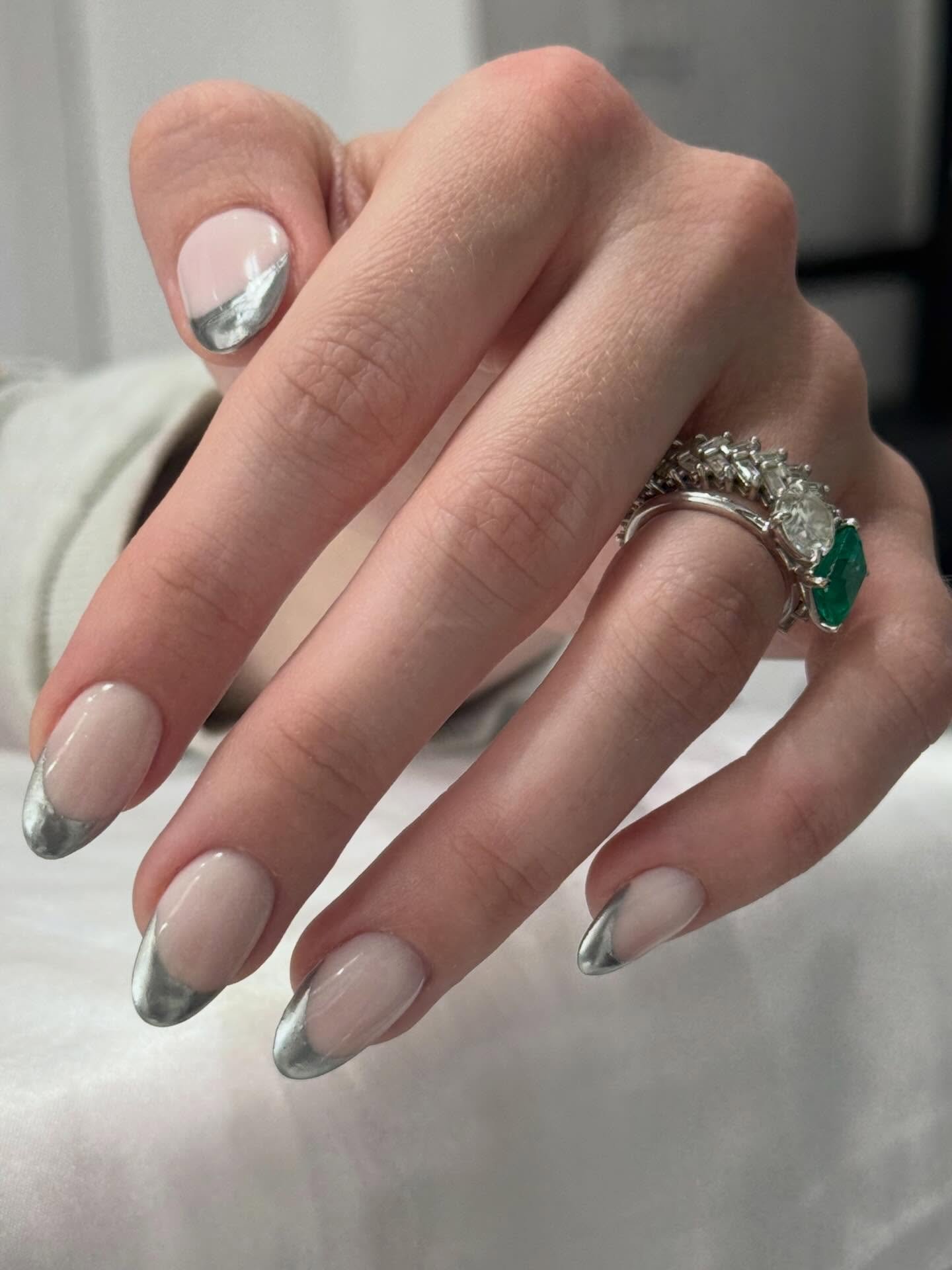 Silver french tip nails design with a glossy nude base and metallic edge.